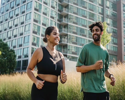 Person actively jogging in a park, symbolizing general health and vitality